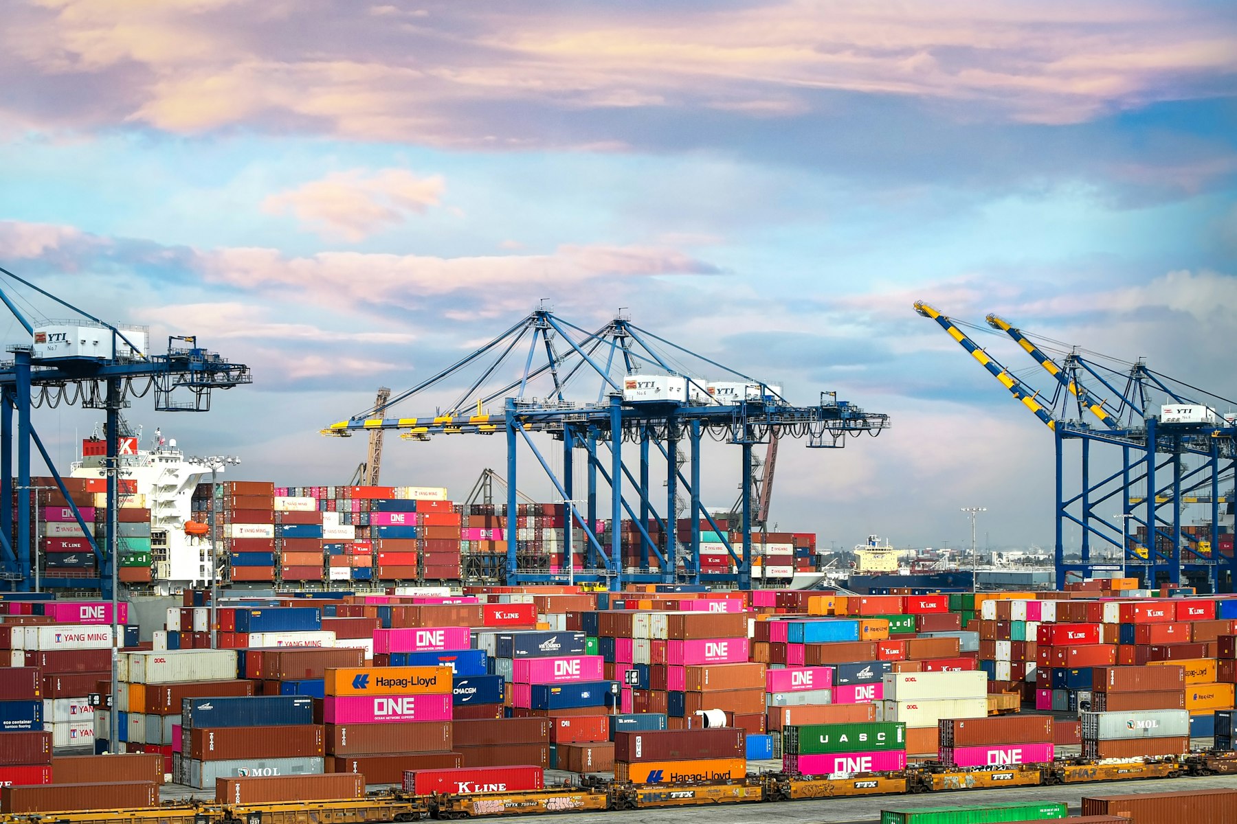 shipping port with cranes and stacked containers